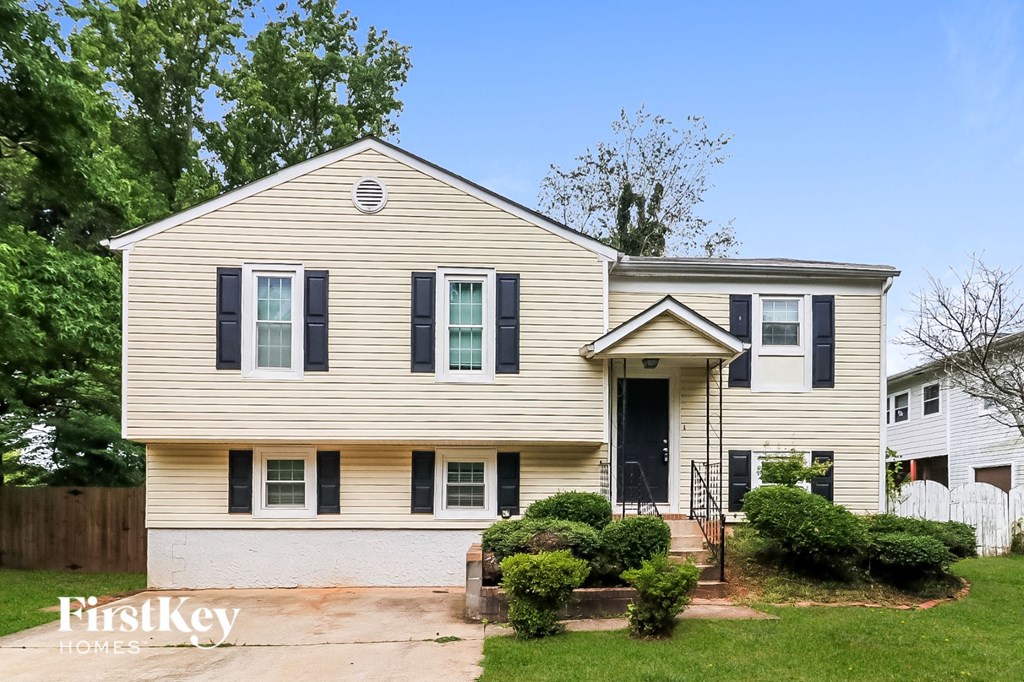 A two-story house with a front porch and a small front yard.