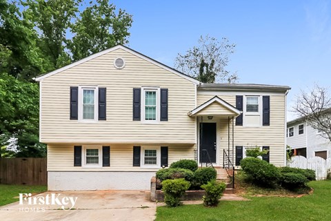 A two-story house with a front porch and a small front yard.
