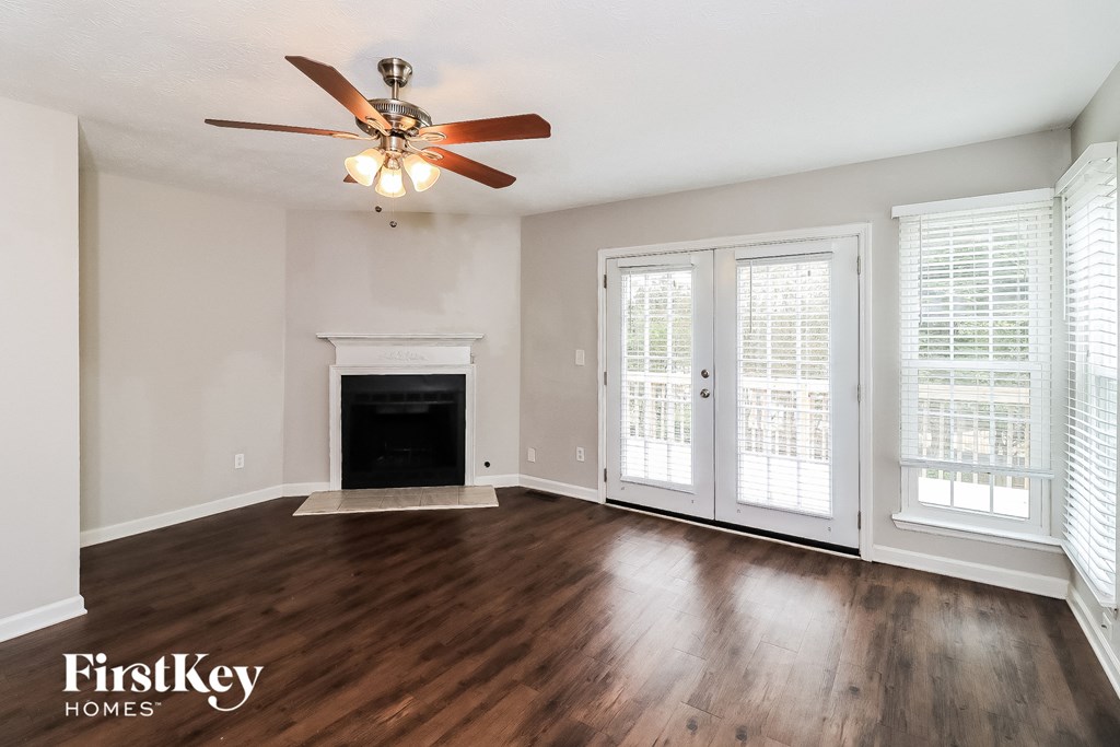 A spacious living room with a fireplace and sliding glass doors.