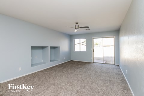 a bedroom with a carpeted floor and a ceiling fan