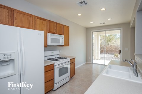 a kitchen with white appliances and wooden cabinets