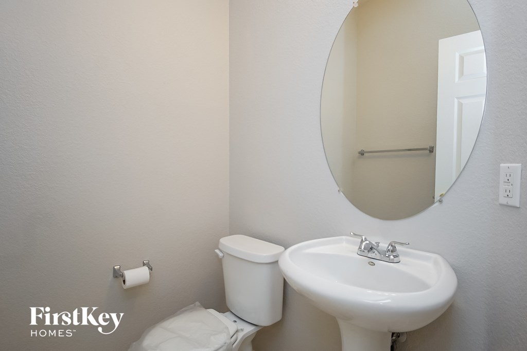 a bathroom with a sink and a mirror and a toilet