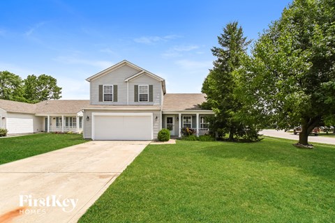 A house with a garage is for sale.
