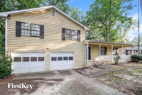 a yellow house with a white garage door
