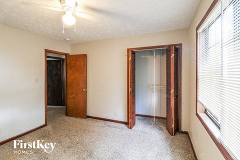 a bedroom with a closet and a window and a door