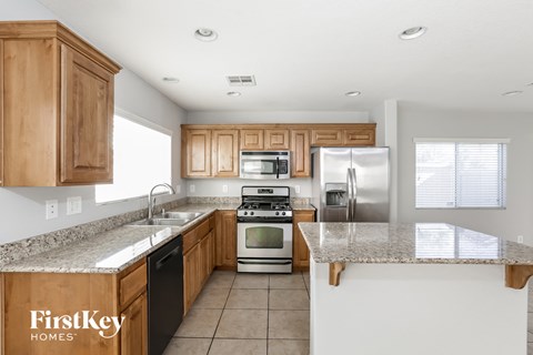 A kitchen with wooden cabinets and granite countertops.