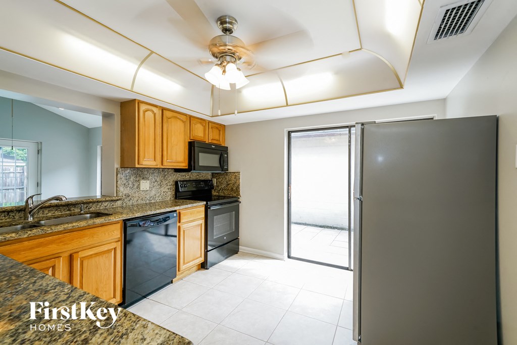 a kitchen with stainless steel appliances and wooden cabinets