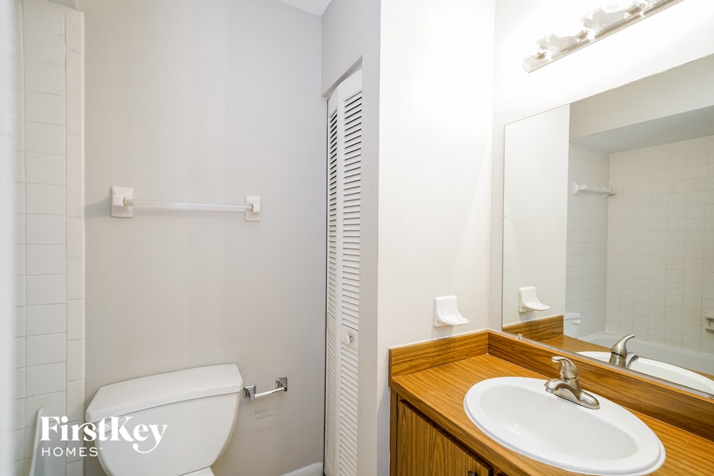 a small bathroom with a toilet sink and mirror