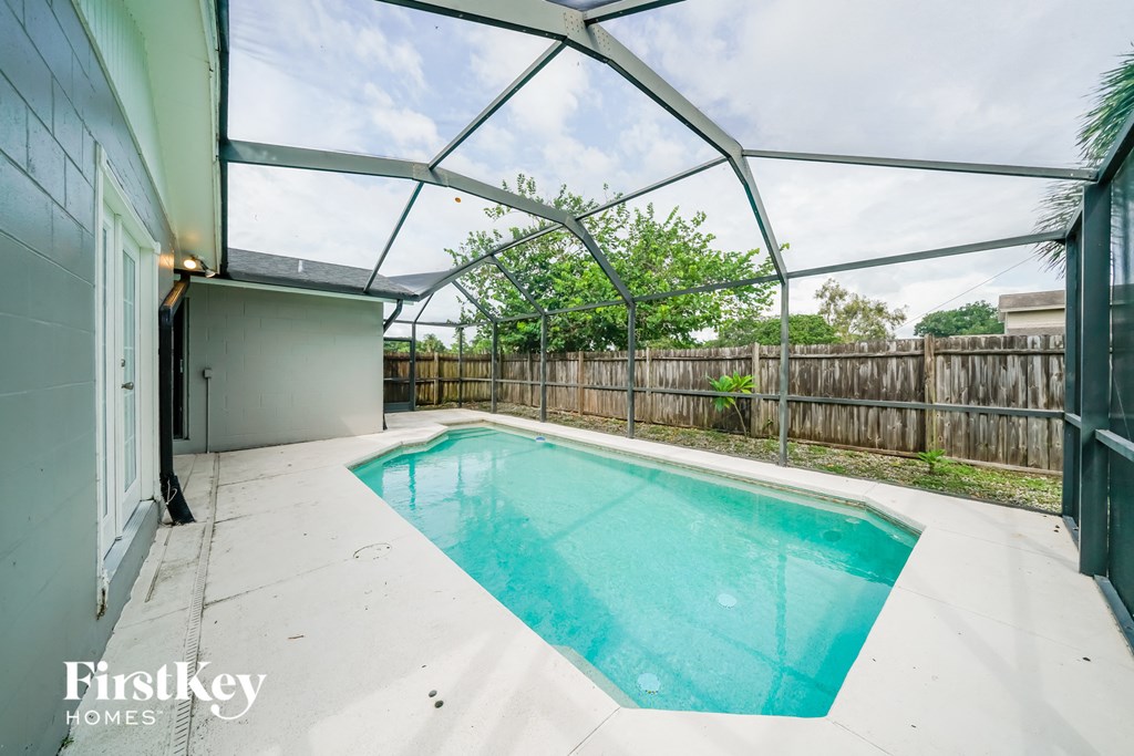 a pool inside of a glass roofed pool house