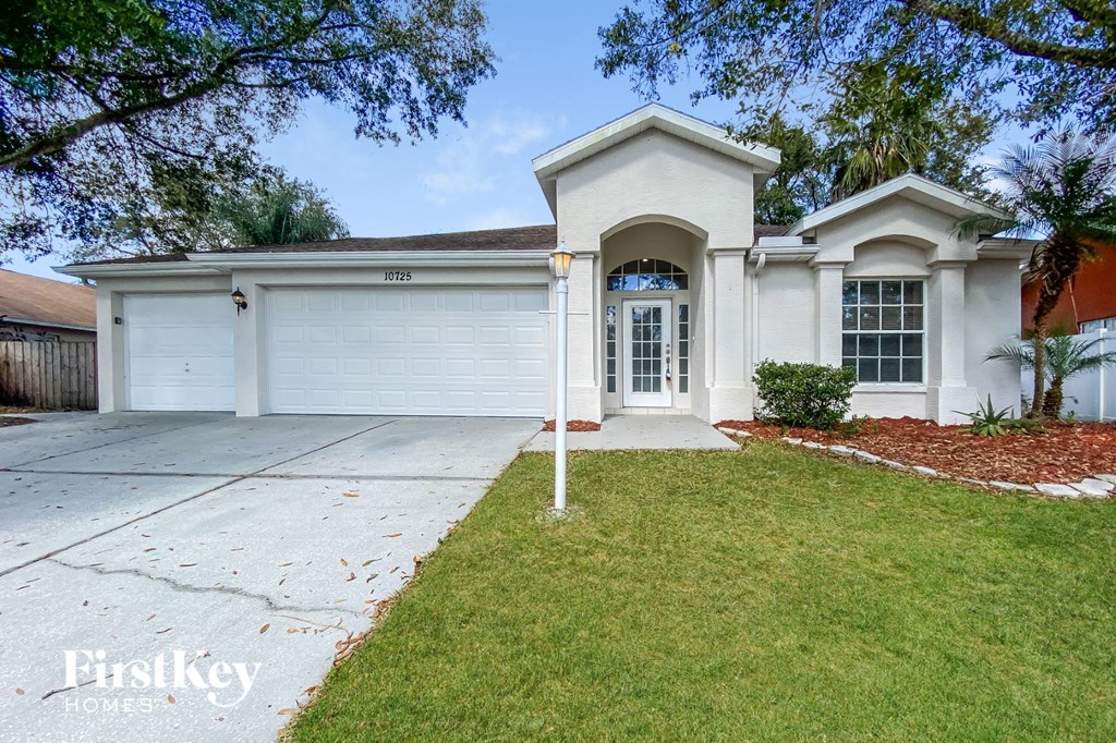 a white house with a driveway and a garage door