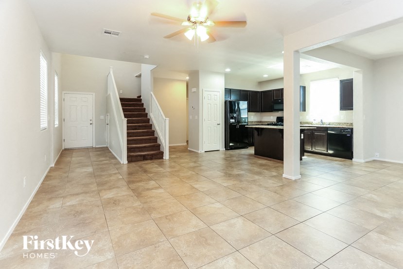 A spacious living room with a staircase leading to the upper floor.