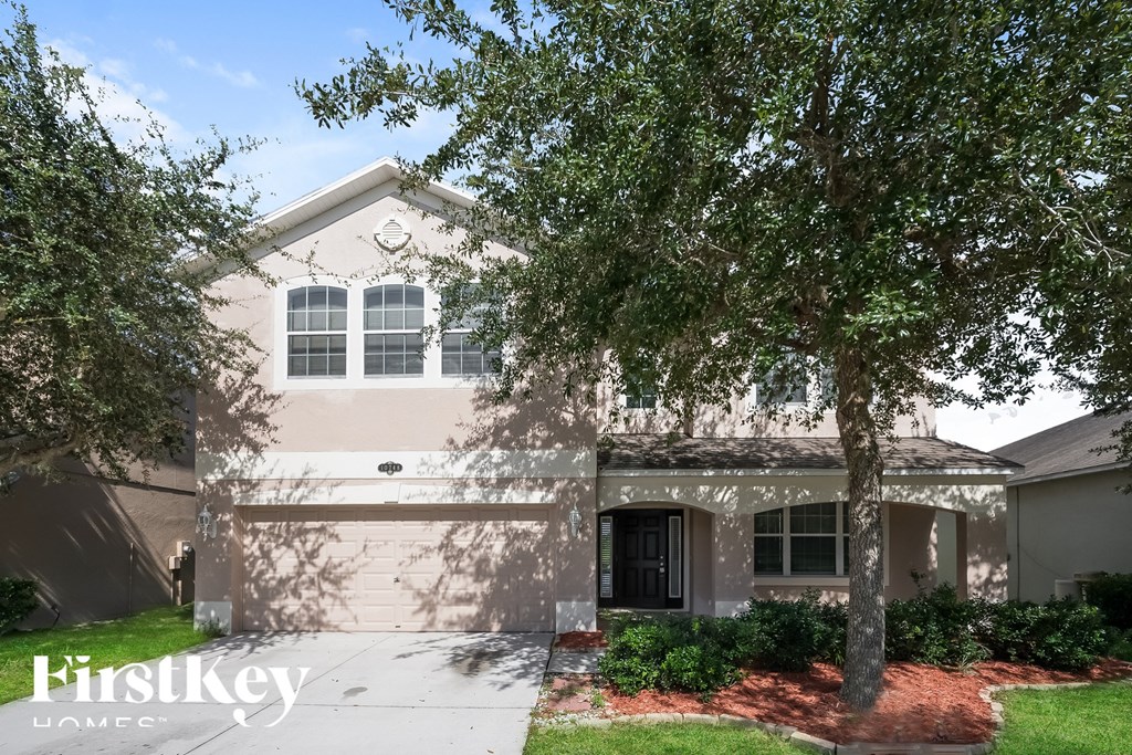 A house with a tree in front of it.