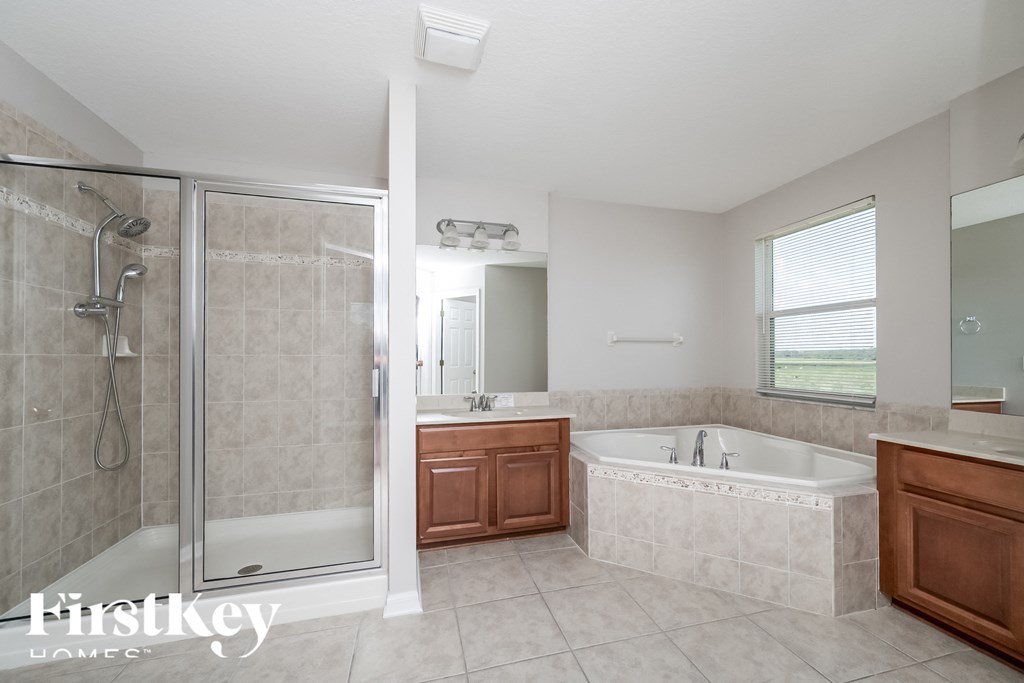 A modern bathroom with a walk-in shower and a bathtub.