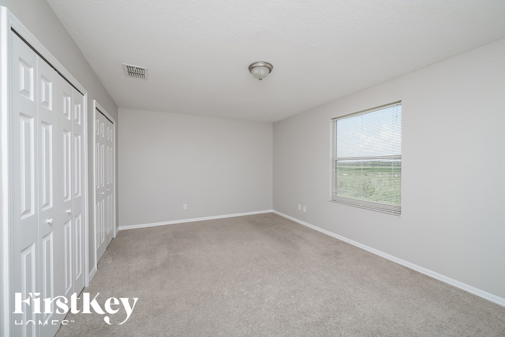 A white room with a window and a door.