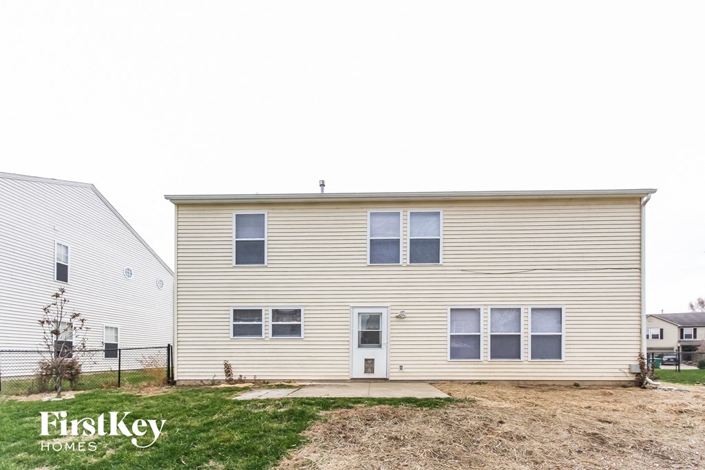 the exterior of a house with a yard in front of it