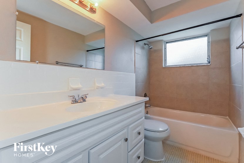 a white bathroom with a toilet and a sink