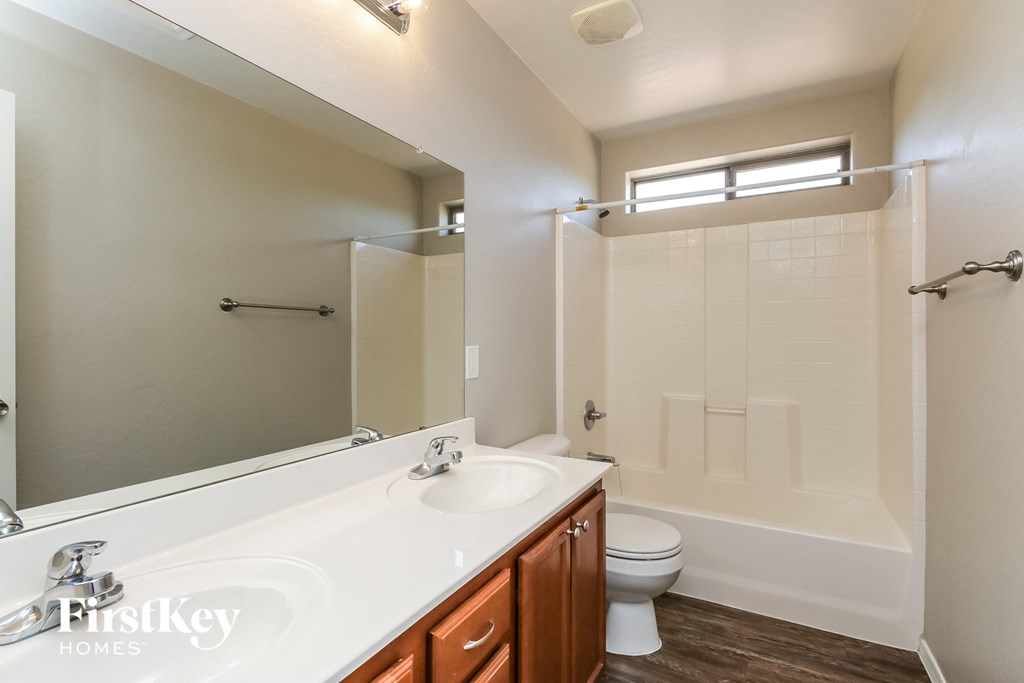 a bathroom with a white sink and a shower and a toilet