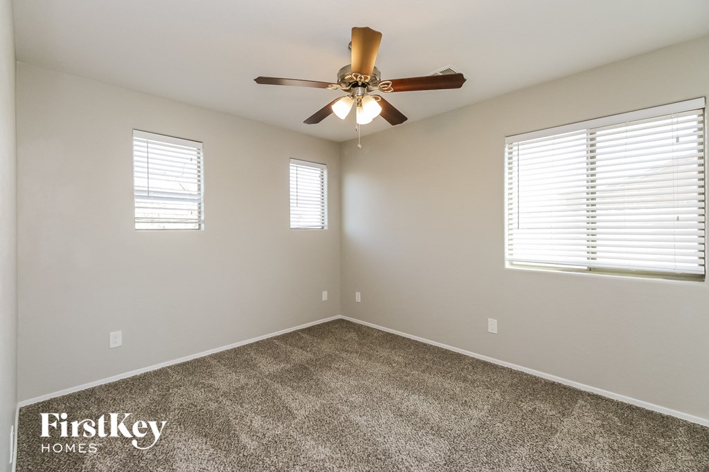 the master bedroom has a ceiling fan and carpeted flooring
