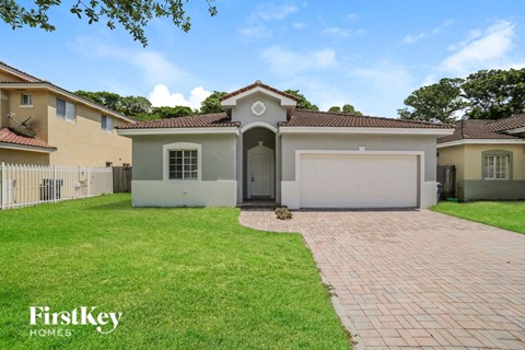 a house with a driveway and a lawn