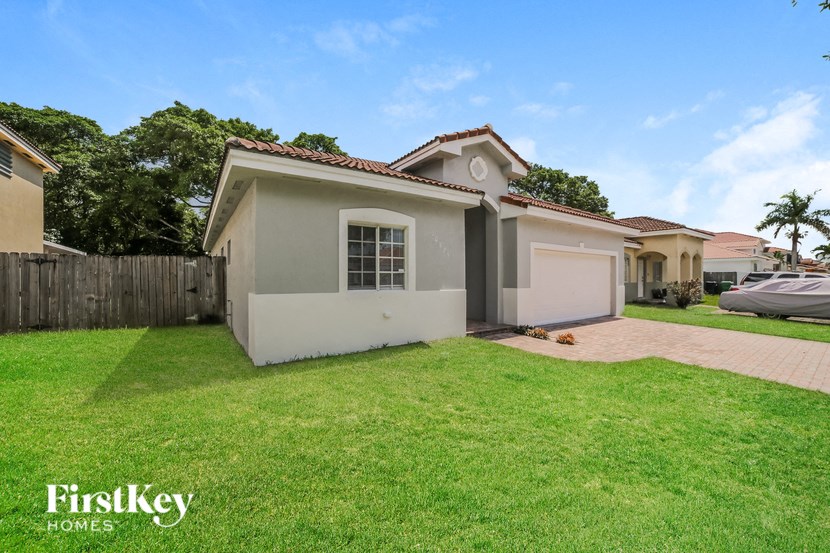 a home with a lawn and a garage