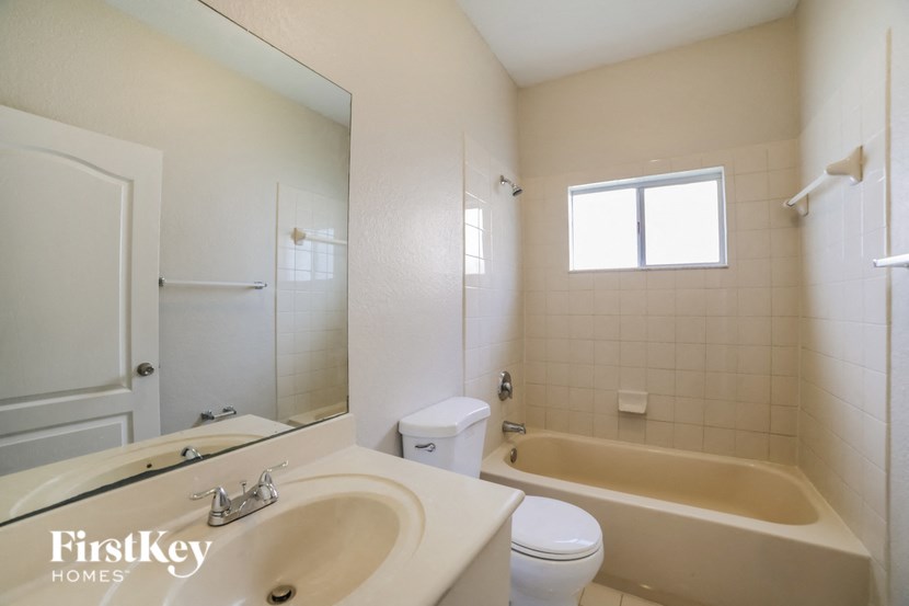 a bathroom with a sink toilet and a bath tub