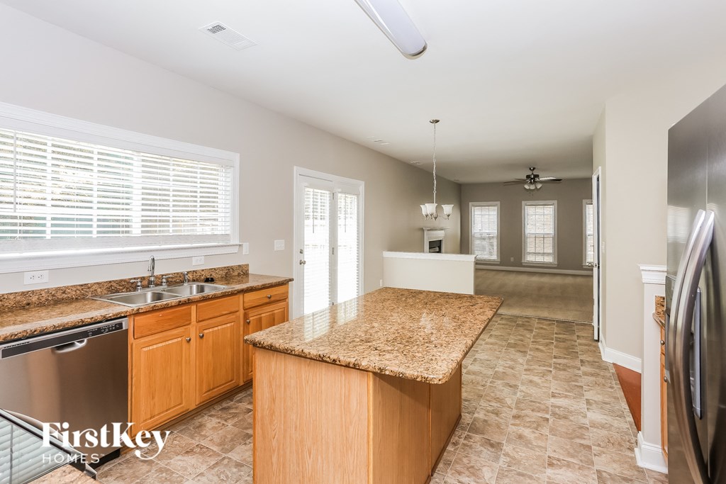a kitchen with granite counter tops and stainless steel appliances