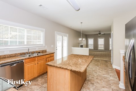 a kitchen with granite counter tops and stainless steel appliances