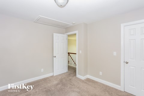 a bedroom with two closets and a door to a hallway