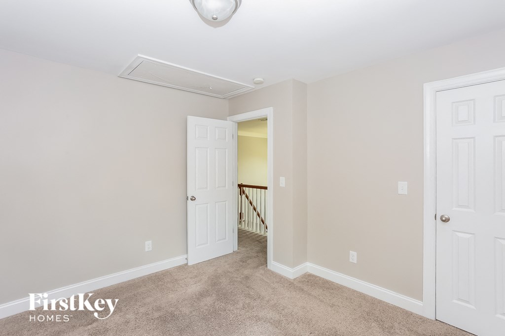 a bedroom with two closets and a door to a hallway