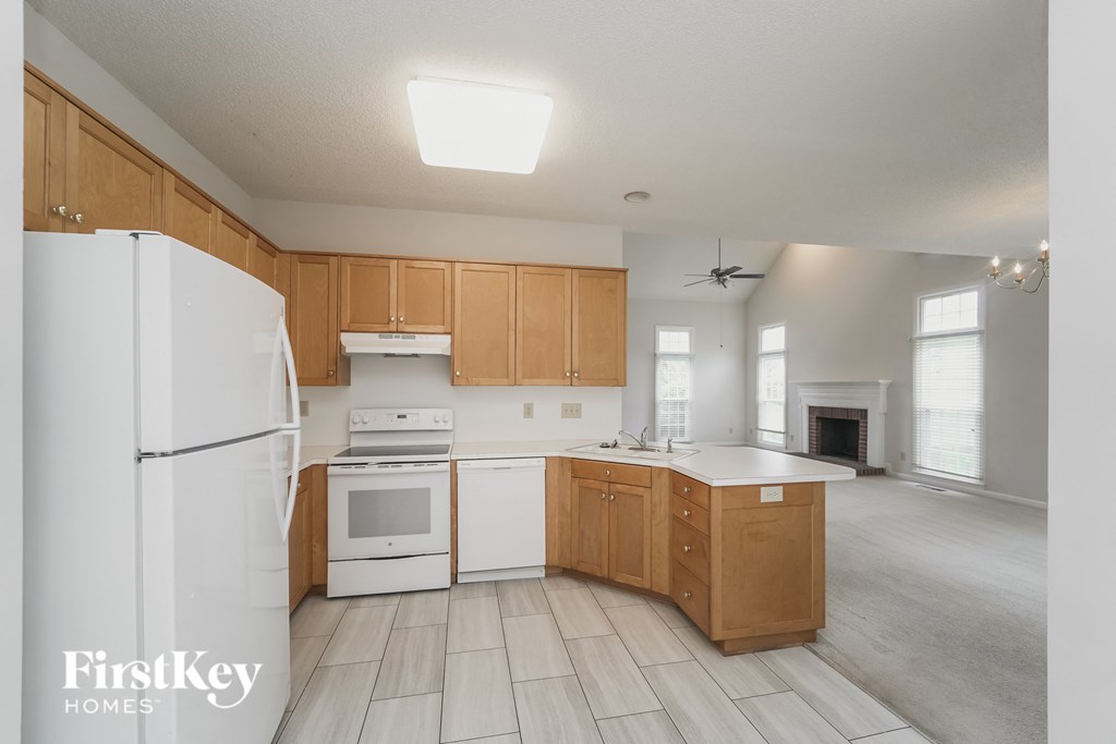 a kitchen with white appliances and wooden cabinets