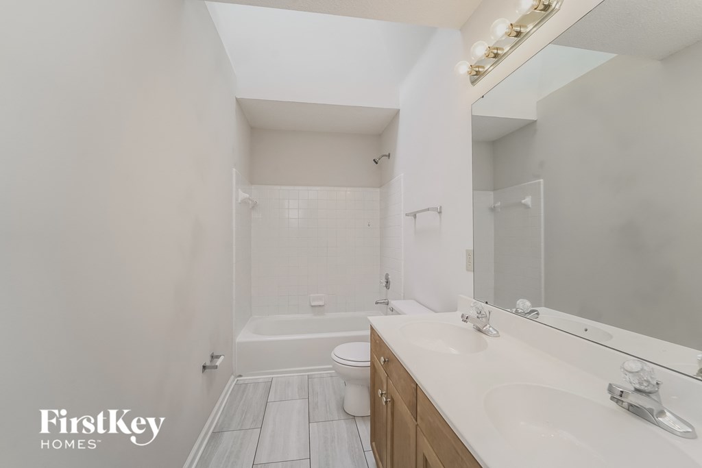 a bathroom with a sink and a toilet and a shower