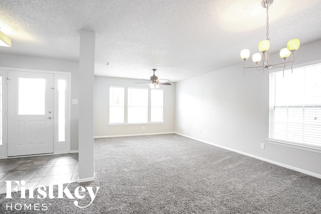 an empty living room with white walls and a white door