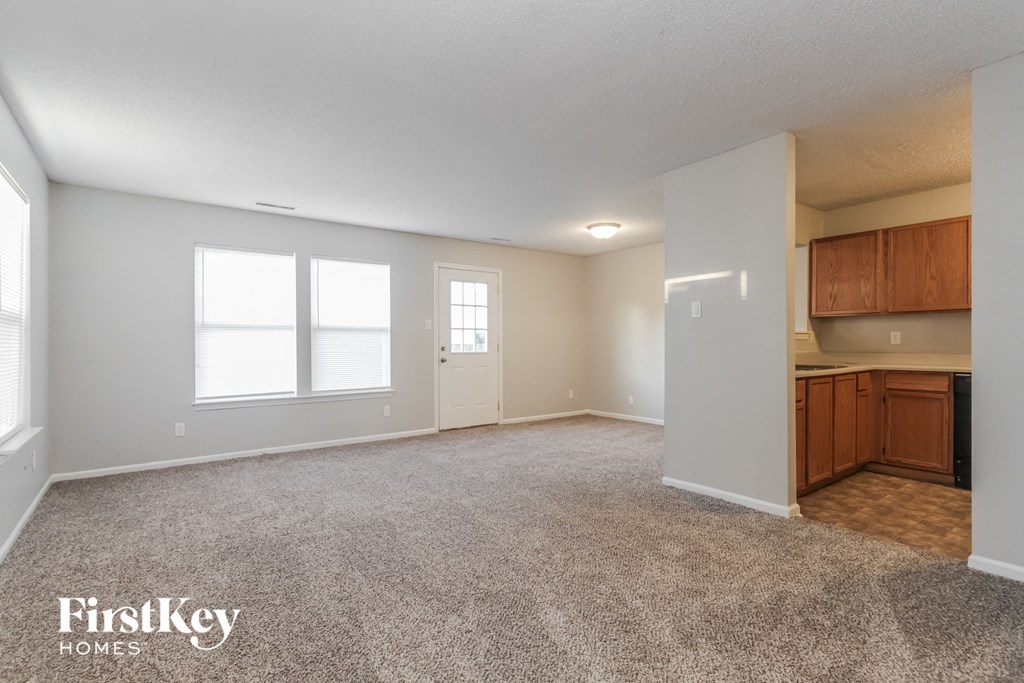 the living room and kitchen of an open floor plan