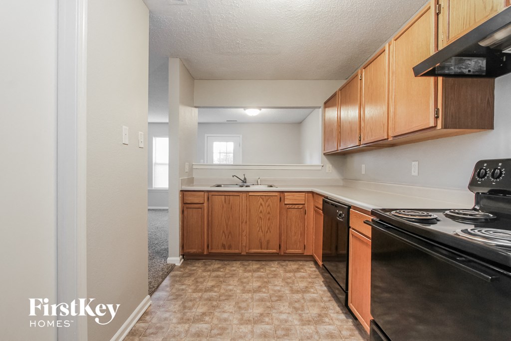 a kitchen with wood cabinets and a stove and a sink