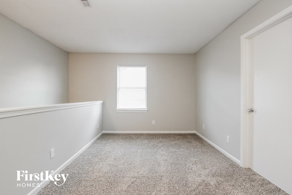 a empty room with white walls and a window