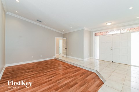 the living room and dining room with wood flooring