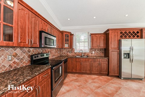 a kitchen with wooden cabinets and stainless steel appliances