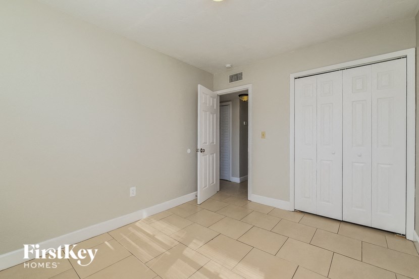 A room with a white door and a white closet.