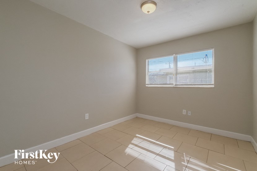 A room with a FirstKey Homes logo on the bottom left corner.