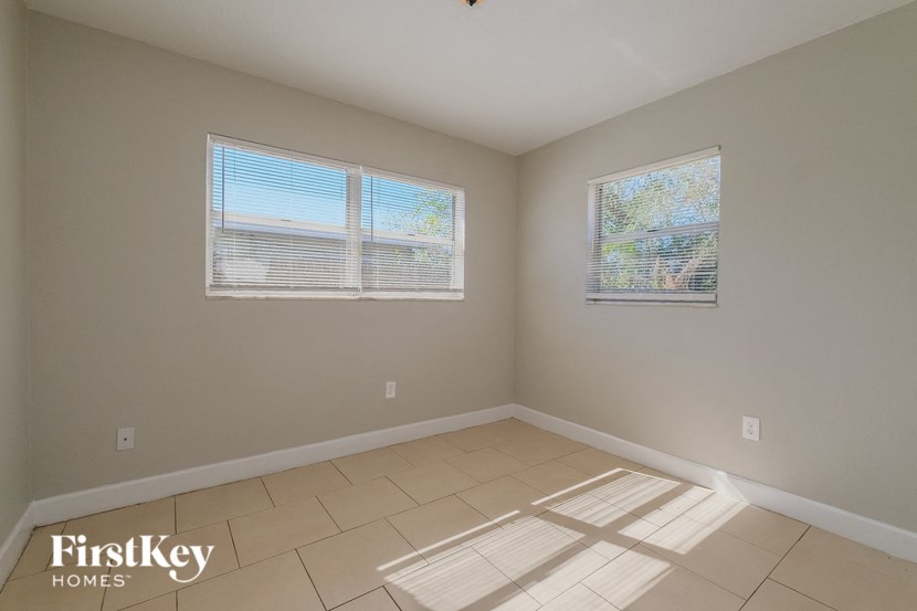 A room with a FirstKey Homes logo on the bottom left corner.