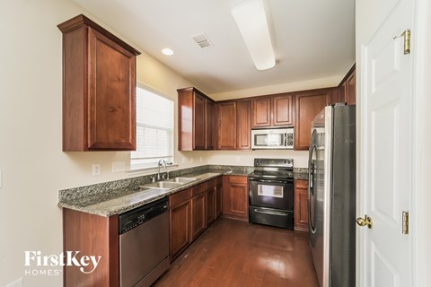 A kitchen with wooden cabinets and stainless steel appliances.