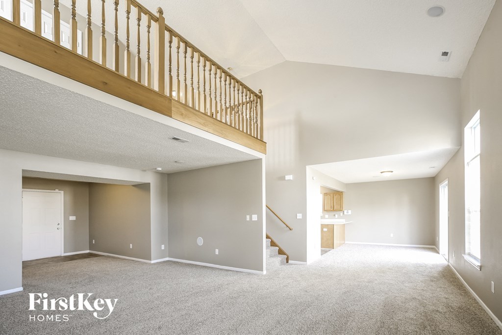 an empty living room with a staircase in a new home
