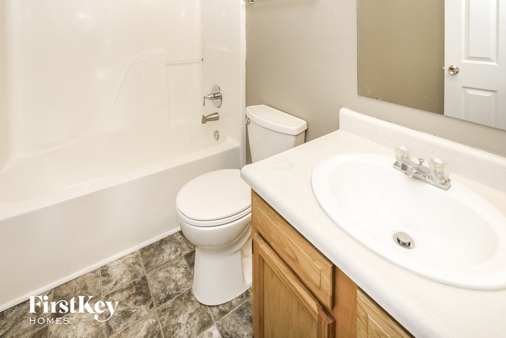 an image of a bathroom with a toilet and a sink
