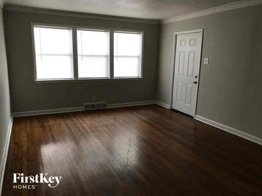 A room with wooden floors and a white door.