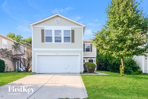 A two-story house with a garage is for sale.