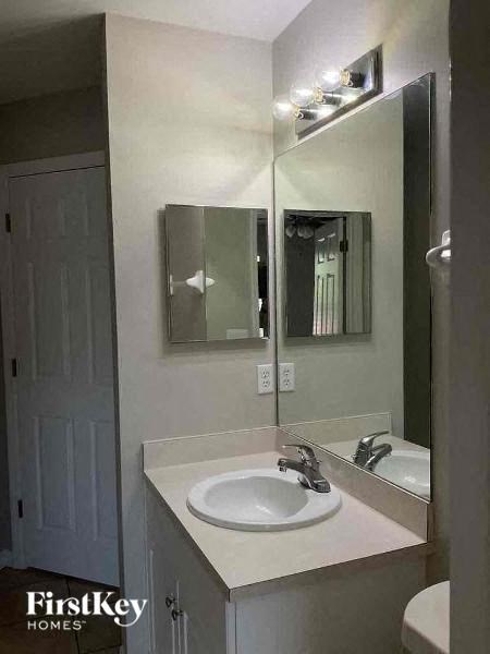 a white bathroom with a sink and a mirror