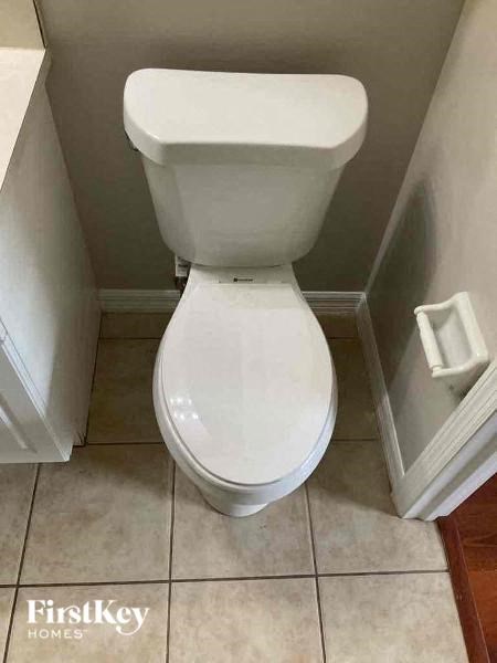 a white toilet in a small bathroom