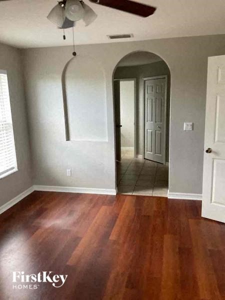 an empty living room with a hard wood floor