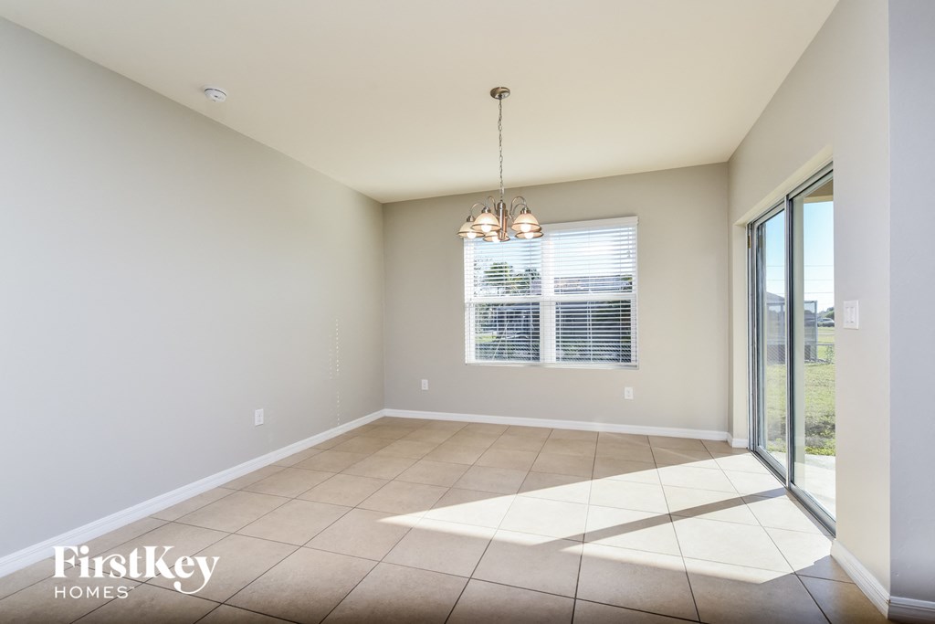 an empty living room with a sliding glass door to a patio