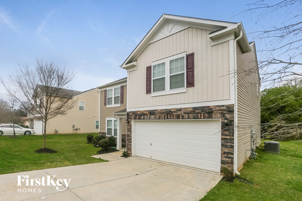A two-story house with a garage is for sale.